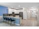 Bright, modern kitchen featuring white cabinets, stainless steel appliances, and a stylish breakfast bar at 8807 Interlocking Ct, Davenport, FL 33896