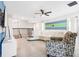 Loft area with a ceiling fan, blue and green stripes on the wall, and a modern white curved couch at 8807 Interlocking Ct, Davenport, FL 33896