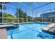 Inviting pool with built-in spa and lush landscaping offers a relaxing outdoor oasis at 8807 Interlocking Ct, Davenport, FL 33896