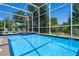 Enjoy this private screened-in pool with clear blue water and lounge chairs, perfect for relaxing at 8807 Interlocking Ct, Davenport, FL 33896