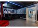 Spacious theater room with seating, a projector, and movie posters, perfect for entertainment at 8807 Interlocking Ct, Davenport, FL 33896