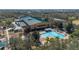 Aerial view of community center with pool and surrounding trees at 9141 Camden Gardens St, Orlando, FL 32827