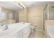 Bright bathroom with double vanity, large mirror, and a walk-in shower at 9141 Camden Gardens St, Orlando, FL 32827