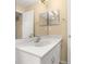 This bathroom features a white vanity and a large mirror for ample natural light at 9141 Camden Gardens St, Orlando, FL 32827