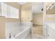 Bright bathroom features a soaking tub and neutral tones, creating a relaxing atmosphere at 9141 Camden Gardens St, Orlando, FL 32827