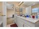 Bathroom with a double sink vanity and access to the bedroom and shower area at 9141 Camden Gardens St, Orlando, FL 32827