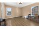 Bright bedroom with two large windows, light-colored walls, and vinyl wood-look flooring at 9141 Camden Gardens St, Orlando, FL 32827
