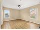 Spacious bedroom with wood flooring and two windows for great natural light at 9141 Camden Gardens St, Orlando, FL 32827