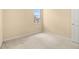 Empty bedroom with neutral carpet, paint, and window at 9141 Camden Gardens St, Orlando, FL 32827