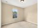 Cozy bedroom featuring soft carpet, a window, and a neutral color scheme at 9141 Camden Gardens St, Orlando, FL 32827
