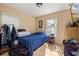 Bedroom with a window providing natural light and furnished with a cozy blue bed and neutral colored walls at 9141 Camden Gardens St, Orlando, FL 32827