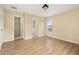 Large bedroom with wood floor, multiple entry ways and a single window at 9141 Camden Gardens St, Orlando, FL 32827