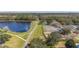 Scenic aerial showcases a serene lake, walking trails, tennis courts, and the beautiful surrounding landscape at 9141 Camden Gardens St, Orlando, FL 32827