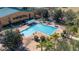 Overhead perspective of the community pool, complemented by surrounding greenery and lounge chairs at 9141 Camden Gardens St, Orlando, FL 32827