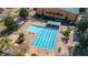 Aerial of the community pool and building, with inviting lounge chairs and lush landscaping at 9141 Camden Gardens St, Orlando, FL 32827