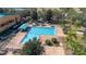Aerial view of the long community swimming pool, with mature landscaping, perfect for exercise or leisurely relaxation at 9141 Camden Gardens St, Orlando, FL 32827