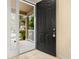 View through an open front door to the entryway and covered front porch at 9141 Camden Gardens St, Orlando, FL 32827
