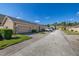 Exterior view of townhomes with neutral exteriors, garages, and nicely landscaped lawns at 9141 Camden Gardens St, Orlando, FL 32827