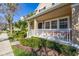 Beautiful two-story home featuring a charming front porch with seating and manicured landscaping at 9141 Camden Gardens St, Orlando, FL 32827