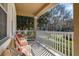 Relaxing front porch showcasing comfortable seating and a view of the serene neighborhood street at 9141 Camden Gardens St, Orlando, FL 32827