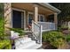 Cozy front porch with white railing leads to a home's entrance framed by manicured greenery at 9141 Camden Gardens St, Orlando, FL 32827