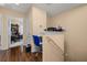 Hallway leading to the study featuring a desk for work and dark wood floors at 9141 Camden Gardens St, Orlando, FL 32827