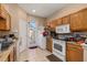 Functional kitchen with essential appliances and tile floors; access door to backyard at 9141 Camden Gardens St, Orlando, FL 32827