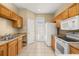 Well-equipped kitchen includes all essential appliances, abundant cabinet space and backyard access at 9141 Camden Gardens St, Orlando, FL 32827