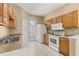 Functional kitchen with ample cabinets, essential appliances, and a door leading outside at 9141 Camden Gardens St, Orlando, FL 32827
