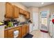 The functional kitchen area features tile flooring, essential appliances, and outside access at 9141 Camden Gardens St, Orlando, FL 32827