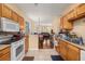 Open concept: kitchen leads to dining & living spaces, creating an inviting atmosphere at 9141 Camden Gardens St, Orlando, FL 32827