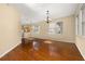 Spacious living room features gleaming hardwood floors, natural light, and modern light fixture at 9141 Camden Gardens St, Orlando, FL 32827