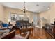 Comfortable living room with hardwood floors, natural light from the windows, and chandelier at 9141 Camden Gardens St, Orlando, FL 32827