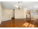 Open-concept living room with hardwood flooring is perfect for entertaining, next to kitchen, stairs at 9141 Camden Gardens St, Orlando, FL 32827