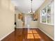 Open concept floorplan with hardwood floors adjacent to the kitchen and a view of the back door at 9141 Camden Gardens St, Orlando, FL 32827