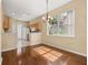 Open-concept space with hardwood floors adjoining the kitchen features a view of the backyard at 9141 Camden Gardens St, Orlando, FL 32827