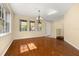Inviting living room with gleaming hardwood floors, large windows, and a chandelier at 9141 Camden Gardens St, Orlando, FL 32827