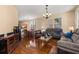 Open-concept living room with hardwood floors, plush seating, and ample natural light at 9141 Camden Gardens St, Orlando, FL 32827