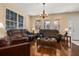 Bright living room featuring hardwood floors, comfortable sofas, and large windows at 9141 Camden Gardens St, Orlando, FL 32827