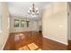Spacious living room with gleaming hardwood floors and multiple windows providing natural light at 9141 Camden Gardens St, Orlando, FL 32827