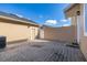View of the backyard patio area with brick pavers, privacy walls, and an access door at 9141 Camden Gardens St, Orlando, FL 32827
