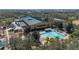 Community center, lush greenery, and a sparkling swimming pool provide an ideal setting for recreation at 9141 Camden Gardens St, Orlando, FL 32827