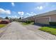 Serene street view showcases well-maintained townhomes with attached garages and lush landscaping at 9141 Camden Gardens St, Orlando, FL 32827