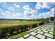 Expansive backyard with landscaped patio, pavers, and lush green space at 9845 Emerald Berry Dr, Winter Garden, FL 34787