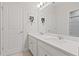 Bright bathroom features a double sink vanity with white cabinets and modern fixtures at 9845 Emerald Berry Dr, Winter Garden, FL 34787