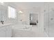 This luxurious primary bathroom features marble tile, dual sinks, soaking tub, and glass shower at 9845 Emerald Berry Dr, Winter Garden, FL 34787