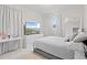 Relaxing bedroom features a soft color palette, ample natural light, and a large wall-mounted television at 9845 Emerald Berry Dr, Winter Garden, FL 34787