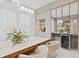 Elegant dining room featuring a built-in wine cooler and modern light fixture at 9845 Emerald Berry Dr, Winter Garden, FL 34787