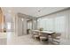 Elegant dining room featuring marble floors, modern lighting, and a mirrored accent wall at 9845 Emerald Berry Dr, Winter Garden, FL 34787