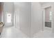 Bright foyer with high ceiling, white marble floors, and adjacent powder room at 9845 Emerald Berry Dr, Winter Garden, FL 34787